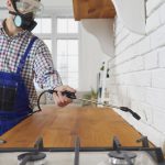 A man spraying too many chemicals is making one of the common home pest control mistakes.