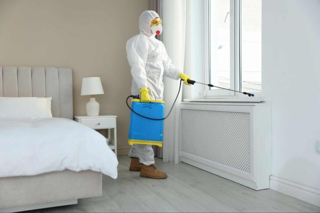 Pest control in hotel industry professional treating a guest room to help prevent pests and maintain clean, safe accommodations.