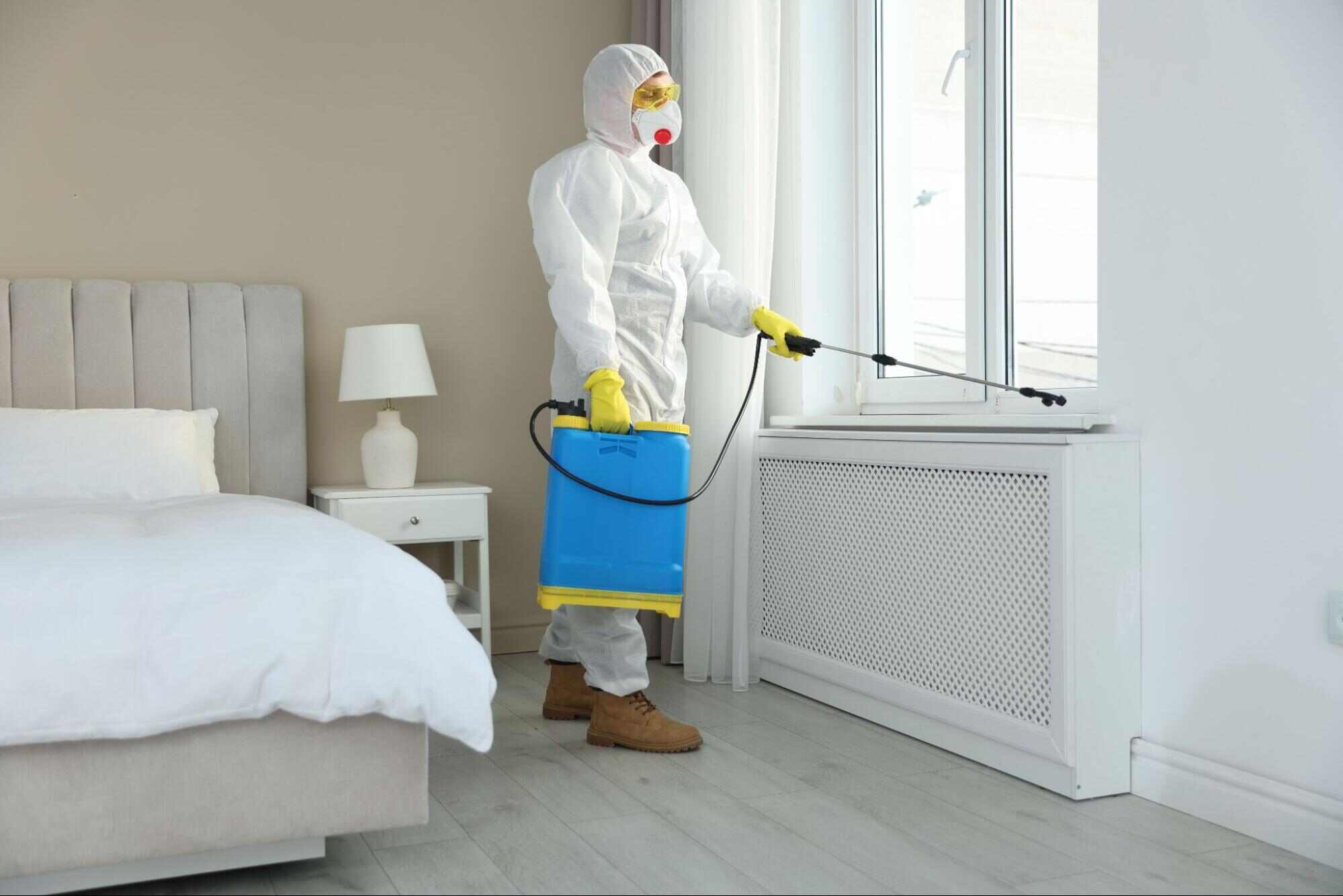 Pest control in hotel industry professional treating a guest room to help prevent pests and maintain clean, safe accommodations.